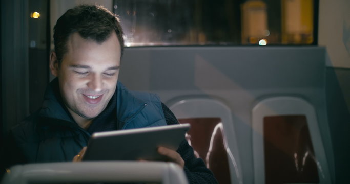 Smiling Man In The Bus With Tablet Computer