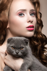 Beautiful young girl,  natural light makeup and curls with a cat