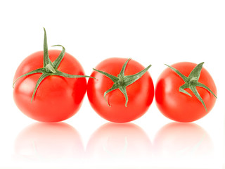 ripe tomato with green leaves