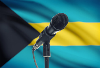Microphone on stand with national flag on background - Bahamas