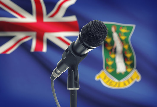 Microphone on stand with national flag on background - British Virgin Islands