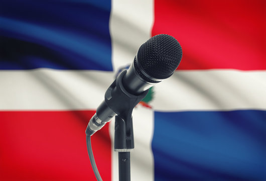 Microphone on stand with national flag on background - Dominican Republic