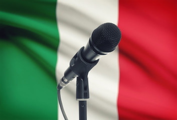 Microphone on stand with national flag on background - Italy