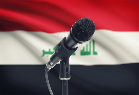 Microphone on stand with national flag on background - Iraq