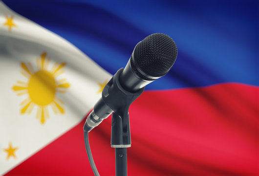 Microphone on stand with national flag on background - Philippines