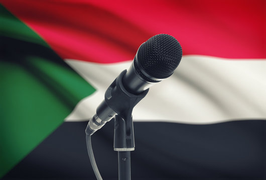 Microphone on stand with national flag on background - Sudan