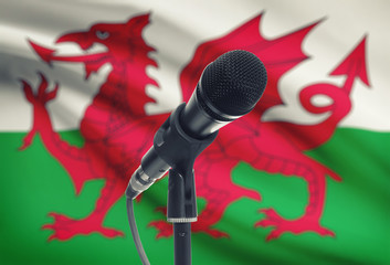 Microphone on stand with national flag on background - Wales