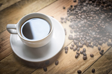 Coffee cup and beans on brown background