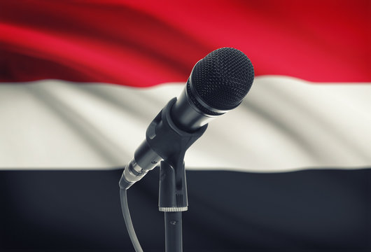 Microphone on stand with national flag on background - Yemen