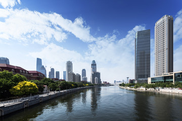 Fototapeta na wymiar modern buildings in urban city at riverbank