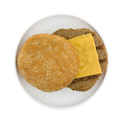 Cheeseburger with bun on small plate