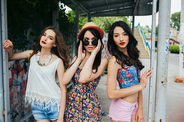 Three beautiful young girls at the bus stop