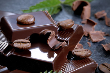 Dark chocolate and coffee bean on a stone table 
