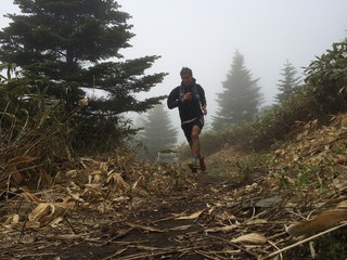 Man running on high mountain trail