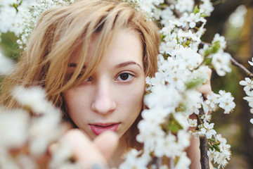 Portrait of a beautiful girl flowering trees