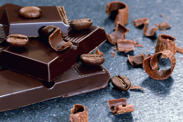Dark chocolate and coffee bean on a stone table 
