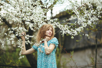 Portrait of a beautiful girl flowering trees