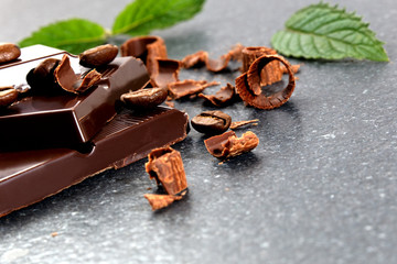 Dark chocolate and coffee bean on a stone table 
