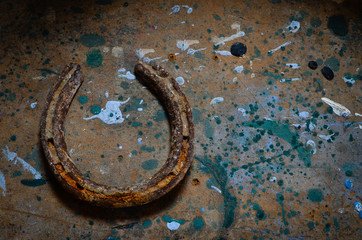 Rusty old horseshoe on a grungy background