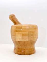 Wooden mortar and pestle on a white background. Kitchen accessories grind spices