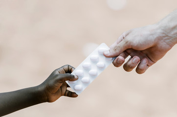 Cure Ebola - White Man Hand Giving Ill Patient Medications