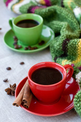 Green and red cups of coffee with coffee Bence, anise star 