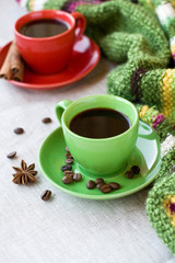 Green and red cups of coffee with coffee Bence, anise star 