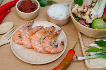 spices and prawn on wooden background 