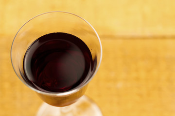glass of red wine on wooden background, close up. Top view
