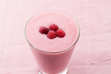 Raspberry smoothie with berries on wooden background. Healthy vegetarian food, diet.