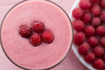 Raspberry smoothie with berries on wooden background. Healthy vegetarian food, diet.