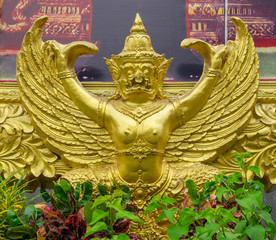 Golden garuda statue under the picture frame