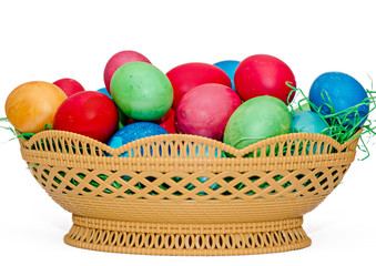 Fototapeta na wymiar Colored easter eggs placed in a basket