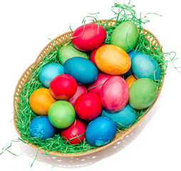 Colored easter eggs placed in a basket