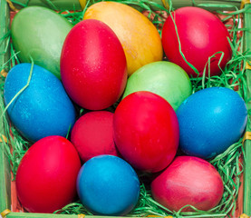 Colored easter eggs placed in a basket