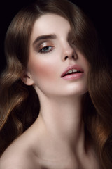 Facial beauty portrait of young girl with chestnut head, big green eyes, pouty lips with natural lipstick on black background