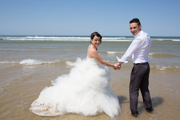 Beautiful couple at the beach happy together