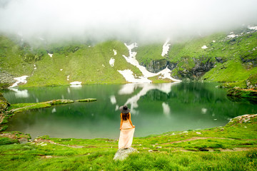 Woman on the mountain lake