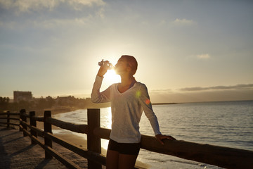 Young runner drinking from a water bottle