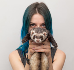 blue haired pretty girl plays with ferret