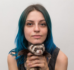 blue haired pretty girl plays with ferret