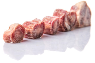Raw frozen ox tail on white background