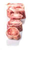 Raw frozen ox tail on white background