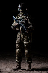 Man in military camouflage with a machine gun in hand