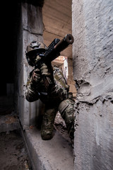 Armed trooper in camouflage with machine gun