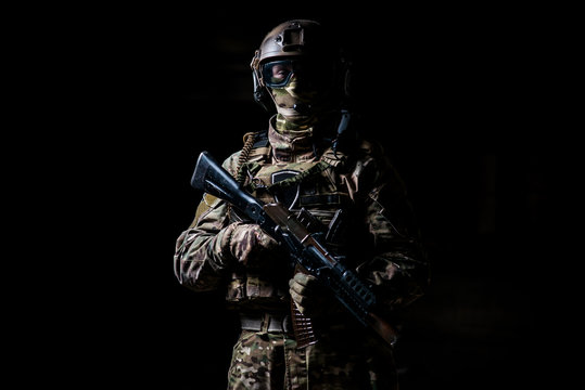 Soldier in camouflage hold machine gun