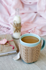 Blue cup of coffee in Knitted sweater, vintage notebook