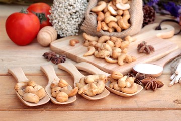 Roasted cashews nuts with natural on wood background