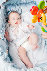 Cute little boy looking at toy 