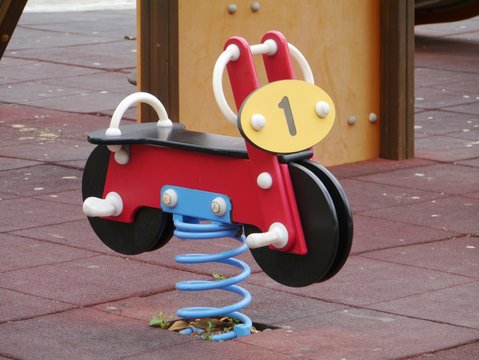 A red bouncing bike number one on a childrens playground